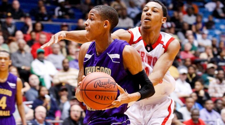 Thurgood Marshall’s Joe Thomassen (24) drives to the basket into the defense of Trotwood-Madison’s Dazhonetae Bennett (15) on March 7, 2012, at UD Arena in Dayton, Ohio. Staff photo by Nick Daggy