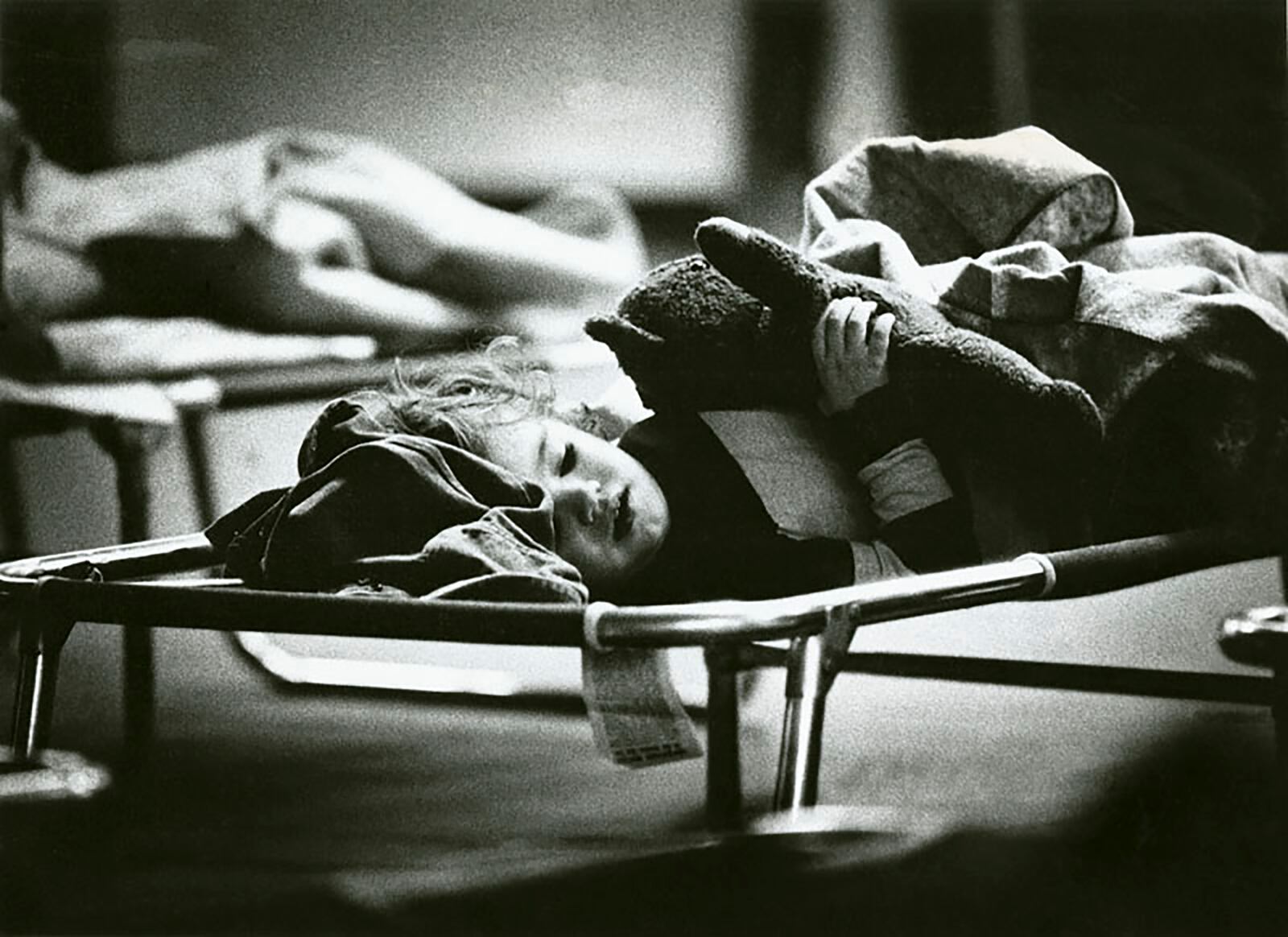 The son of John and Nancy Tenjeras enjoys a nap at the Greyhound Station. Schools, churches, and municipal buildings were often used as makeshift shelters during the blizzard OF 1978.  DAYTON DAILY NEWS ARCHIVE