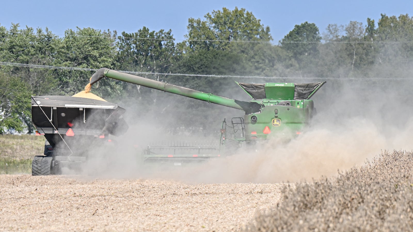 Farmers harvest soybeans in a field near Ohio 202 near Tipp City on Monday, Sept. 29, 2025.  BRYANT BILLING/STAFF