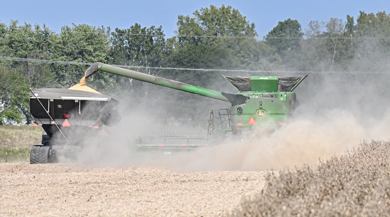 Farmers harvest soybeans in a field near Ohio 202 near Tipp City on Sept. 29, 2025. Tariffs on China and stalled trade negotiations are threatening the financial stability of soybean farmers nationwide. BRYANT BILLING / STAFF
