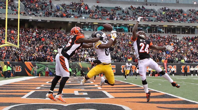 Antonio Brown of the Steelers couldn't catch this pass while being defended by the Bengals' Shawn Williams (#36) and Adam Jones during the third quarter at Paul Brown Stadium on December 18, 2016.