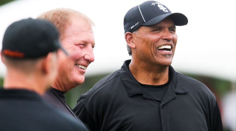 Former Bengal Anthony Munos and radio announcer Dave Lapam talk during Bengals practice, Wednesday, July 31, 2013. GREG LYNCH / STAFF
