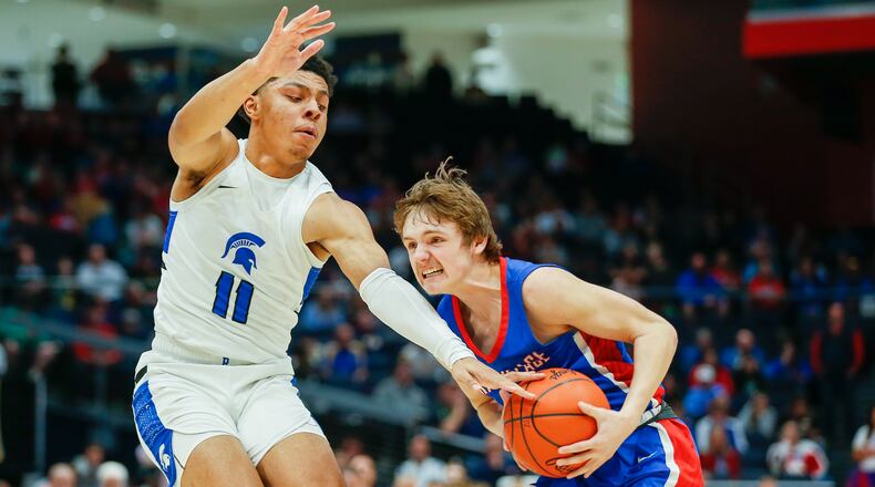 Tri-Village High School senior Wilson Suggs is guarded by Richmond Heights senior Detric Hearst, Jr. during the Division IV state championship game on Sunday at UD Arena. CONTRIBUTED PHOTO BY MICHAEL COOPER