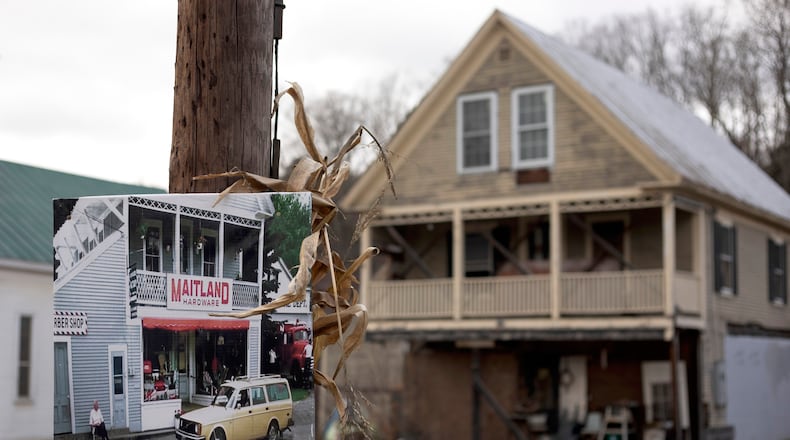 A photo of Maitland Hardware, the fictional hardware store featured in the first "Beetlejuice" film, hangs on a pole in front of the real hardware store used in the filming in East Corinth, Vt., Oct. 28, 2025. (AP Photo/Amanda Swinhart)