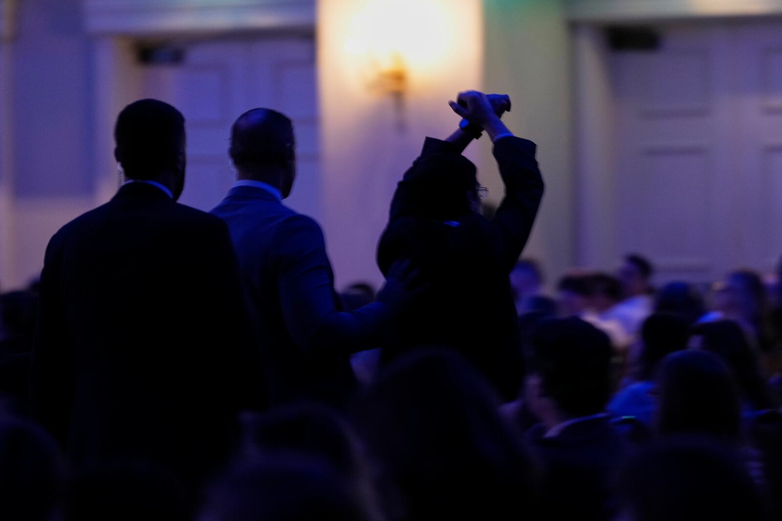 A protester, right, is escorted out of the room as Health and Human Services Secretary Robert F. Kennedy Jr. speaks at the Rx and Illicit drug Summit, Thursday, April 24, 2025, in Nashville, Tenn. (AP Photo/George Walker IV)
