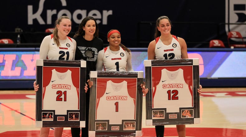 Dayton coach Shauna Green poses for a photo with seniors Erin Whalen, Araion Bradshaw and Jenna Giacone after a game against Saint Louis on Saturday, Feb. 20, 2021, at UD Arena. David Jablonski/Staff
