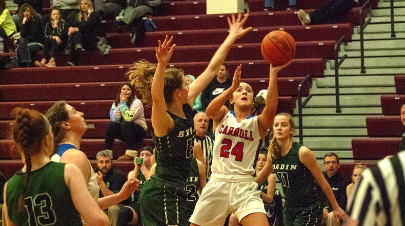 Carroll’s Allie Stefanek shoots over Hamilton Badin’s Maddie Thompson on Monday night at Lebanon High School . Carroll defeated Badin 40-22 to advance to Friday’s Division II district final at Mason. Jeff Gilbert/CONTRIBUTED