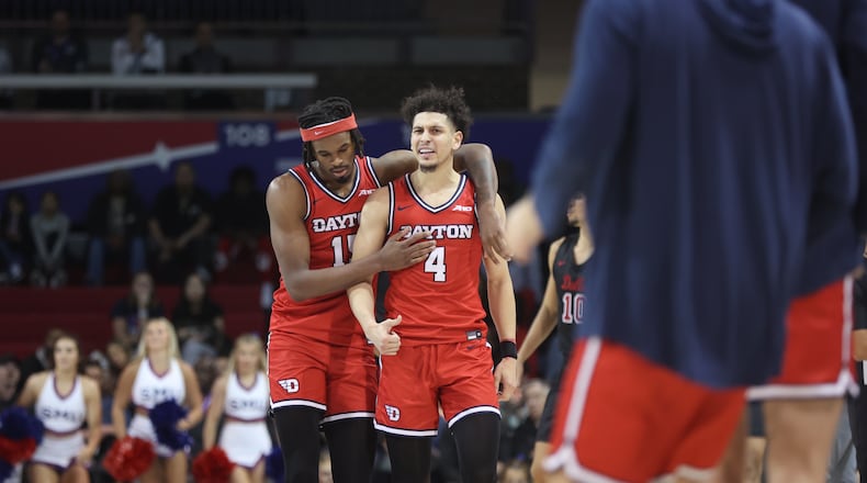 Dayton's DaRon Holmes congratulates Koby Brea after a 3-pointer in the final minutes against Southern Methodist on Wednesday, Nov. 29, 2023, at Moody Coliseum in Dallas, Texas. David Jablonski/Staff