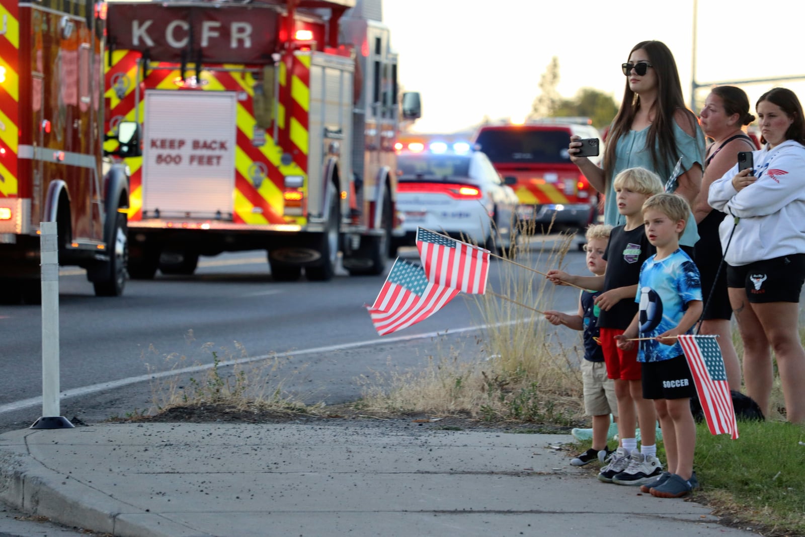 A procession from Kootenai Health headed to Spokane after a few firefighters were killed Sunday, June 29, 2025, when they were ambushed by sniper fire while responding to a blaze in a northern Idaho mountain community, in Coeur d’Alene, Idaho. (Bill Buley/Coeur D'Alene Press via AP)
