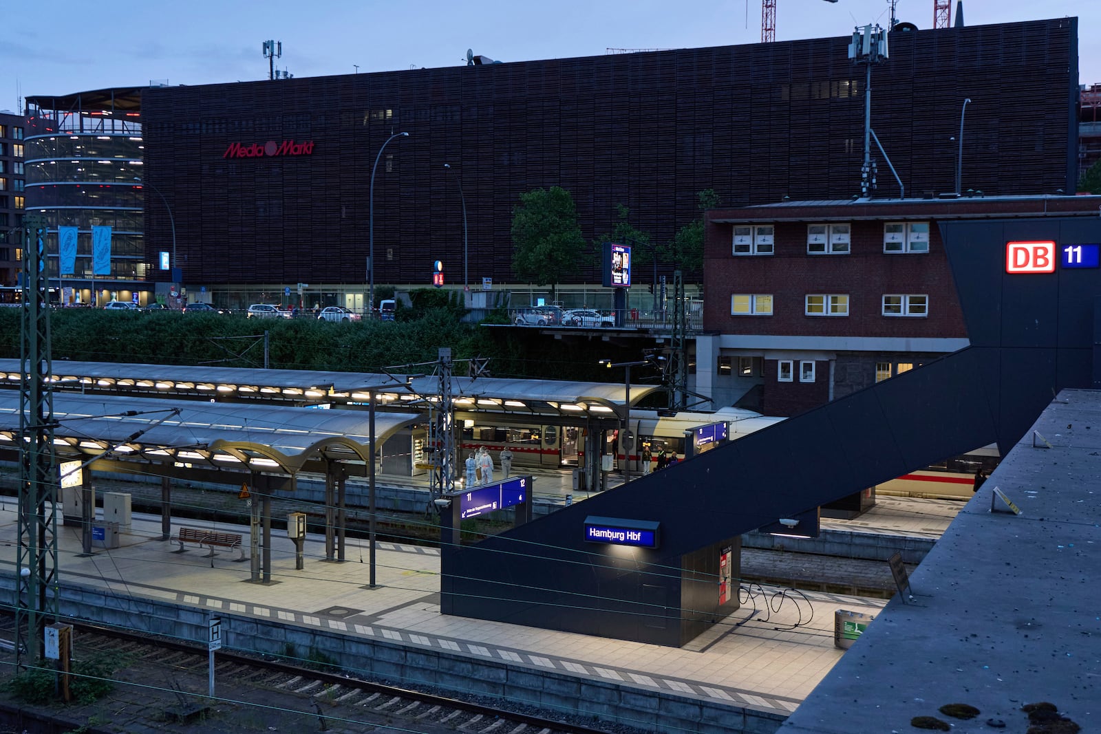 Investigators work at Hamburg, Germany's Central Station on Friday, May 23, 2025, after several people were injured in a knife attack. (Georg Wendt/dpa via AP)