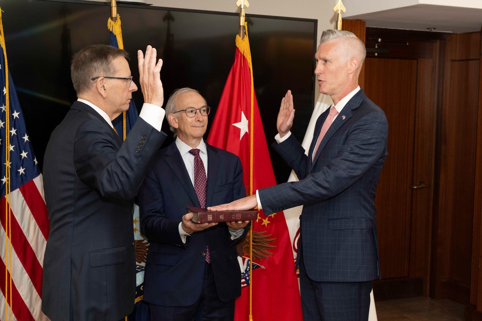 A photo posted on the LinkedIn site of Paul Lawrence, left, deputy secretary of veterans affairs, swearing in Richard Topping, a former executive of Dayton's CareSource. Holding the BIble in this photo is Michael Gessel, an executive with the Dayton Development Coalition.