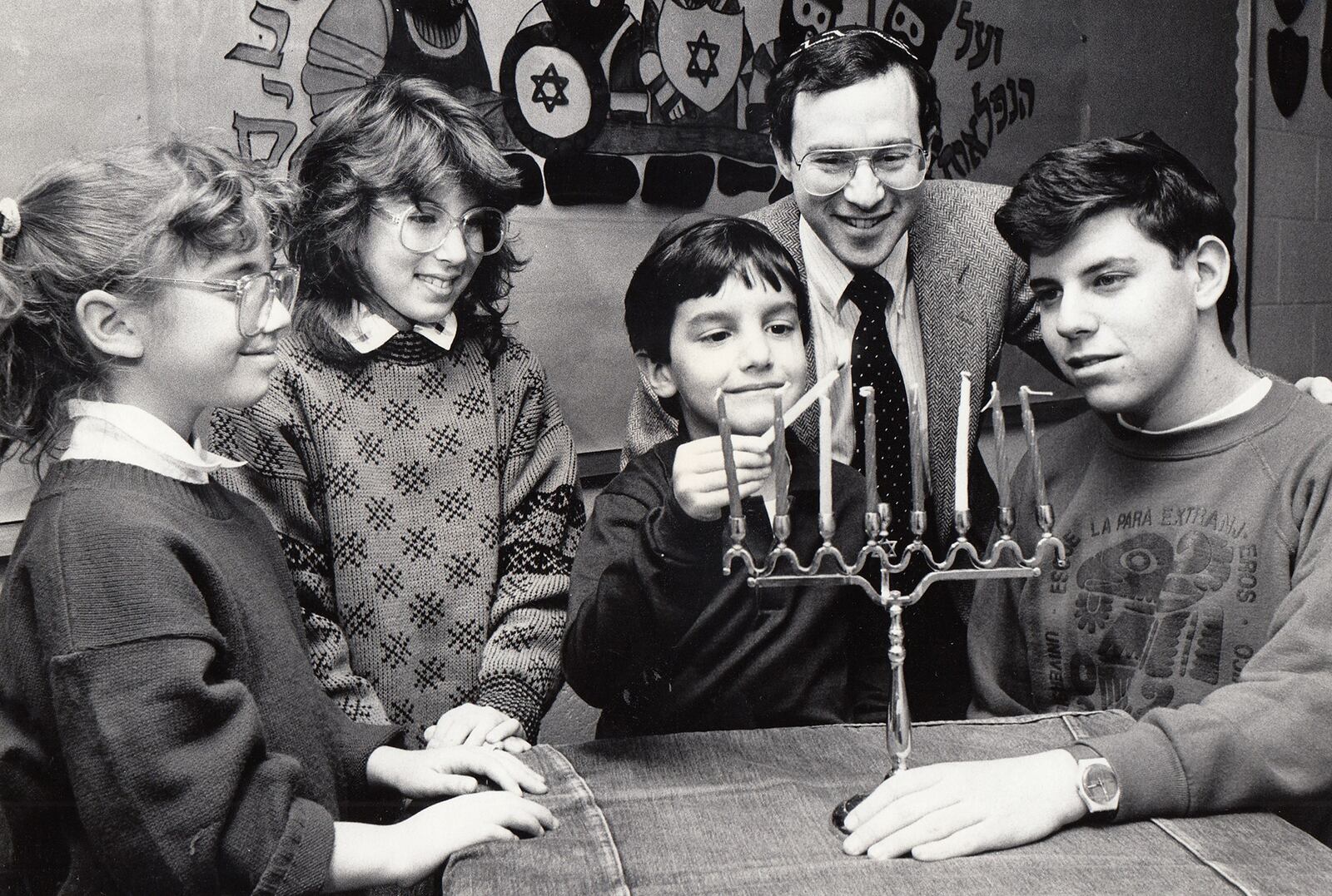 Allison Sherman, Amy Blumhof, Harris Schneiderman and George Abrams prepare for Hanukkah with Rabbi Lifschitz at Hillel Academy in 1986. DAYTON DAILY NEWS ARCHIVE