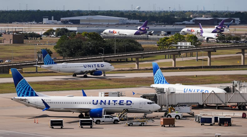 United Airlines and FedEx prepare for departure at George Bush Intercontinental Airport on Friday, Nov. 7, 2025, in Houston. (AP Photo/Ashley Landis)