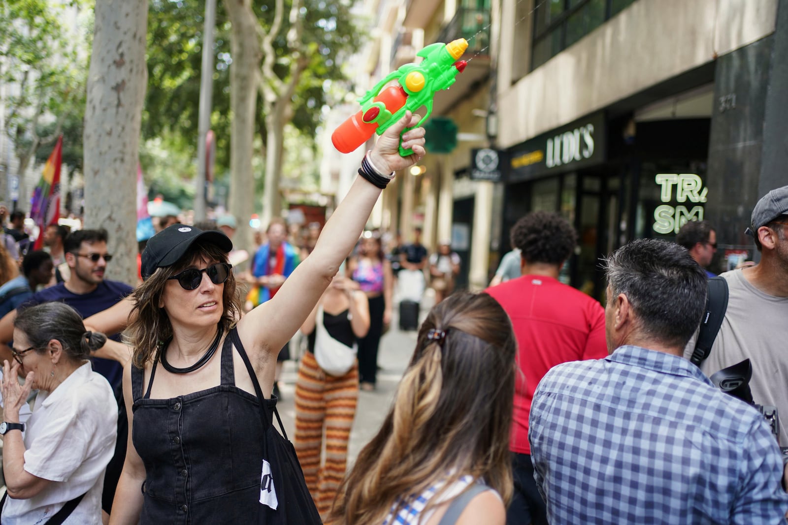 A protester with a water gun takes part in a protest against overtourism in Barcelona, Spain, Sunday, June 15, 2025. (AP Photo/Pau Venteo)