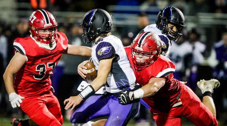Madison’s Cole Pelgen gets a sack on Cincinnati Hills Christian Academy’s Cole Fisher during their 50-6 win over in their Division V, Region 20 football semifinal, Saturday, Nov. 10 at Lakota East High School in Liberty Township. NICK GRAHAM/STAFF