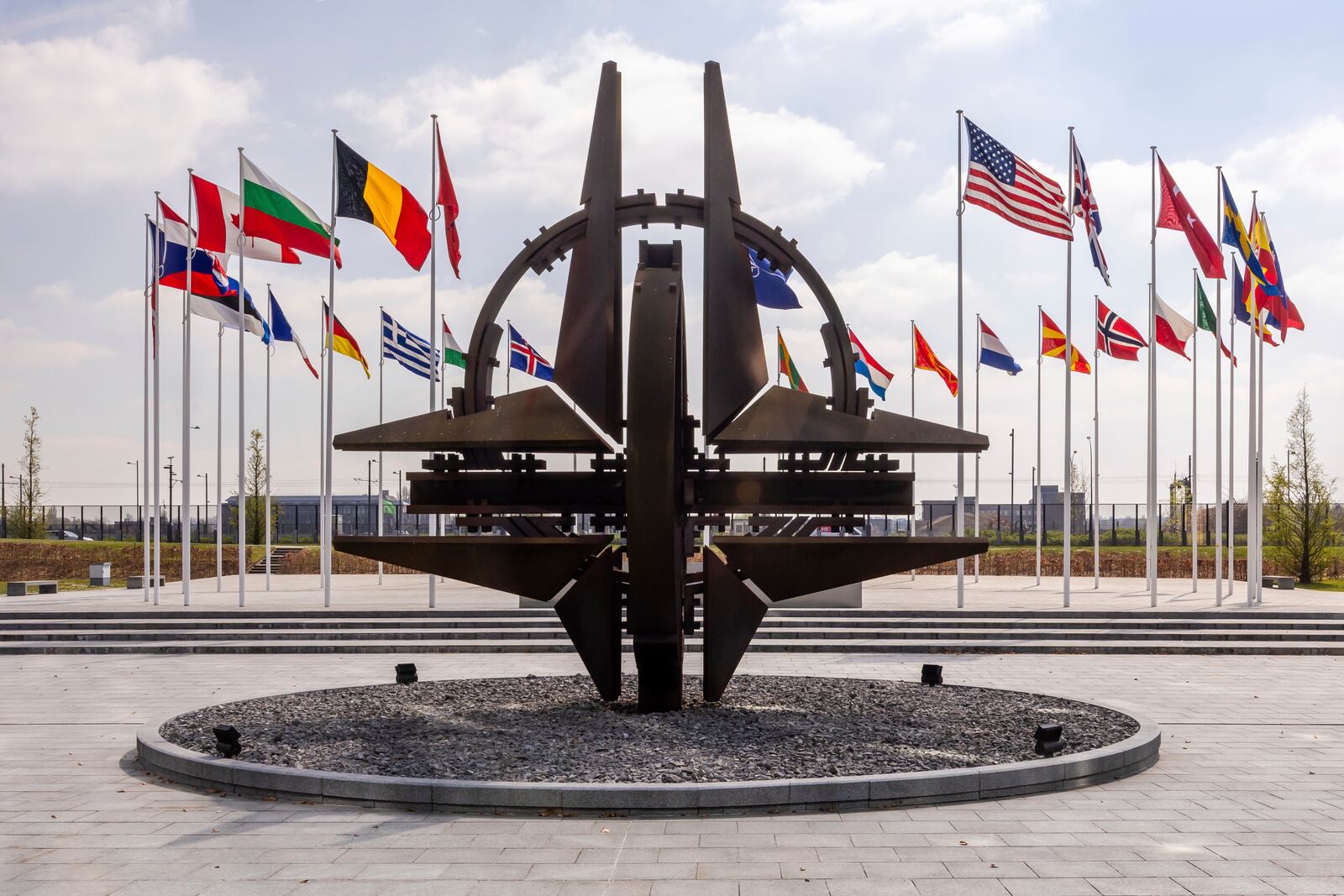 Flags of the Alliance members flap in the wind prior to a coalition of the willing defence ministers meeting at NATO headquarters in Brussels, Belgium, Thursday, April 10, 2025. (AP Photo/Geert Vanden Wijngaert)