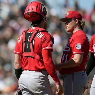 Cincinnati Reds manager Terry Francona, left, arrives at the pitcher's mound to replace Reds starting pitcher Andrew Abbott (41) as Reds catcher Tyler Stephenson looks on during the third inning of a spring training baseball game Friday, March 6, 2026, in Scottsdale, Ariz. (AP Photo/Ross D. Franklin)