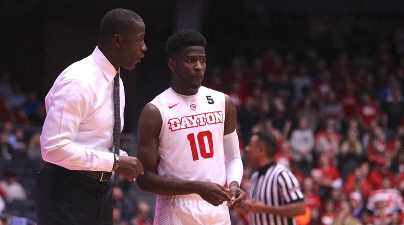 Dayton’s Anthony Grant talks to Jalen Crutcher during a game against Auburn on Wednesday, Nov. 29, 2017, at UD Arena. David Jablonski/Staff