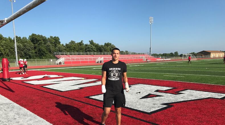 Issiah Evans stands at the edge of the Trotwood Madison field during summer workout the other evening. Although he suffered serious injuries, including the loss of his right hand, in a fireworks accident just 19 days ago, and had ACL surgery in the spring, he vows he will play again his season. Last year, as a sophomore linebacker, he was one of the leaders of the team. He’s also a 4.2 GPA student Tom Archdeacon photo)