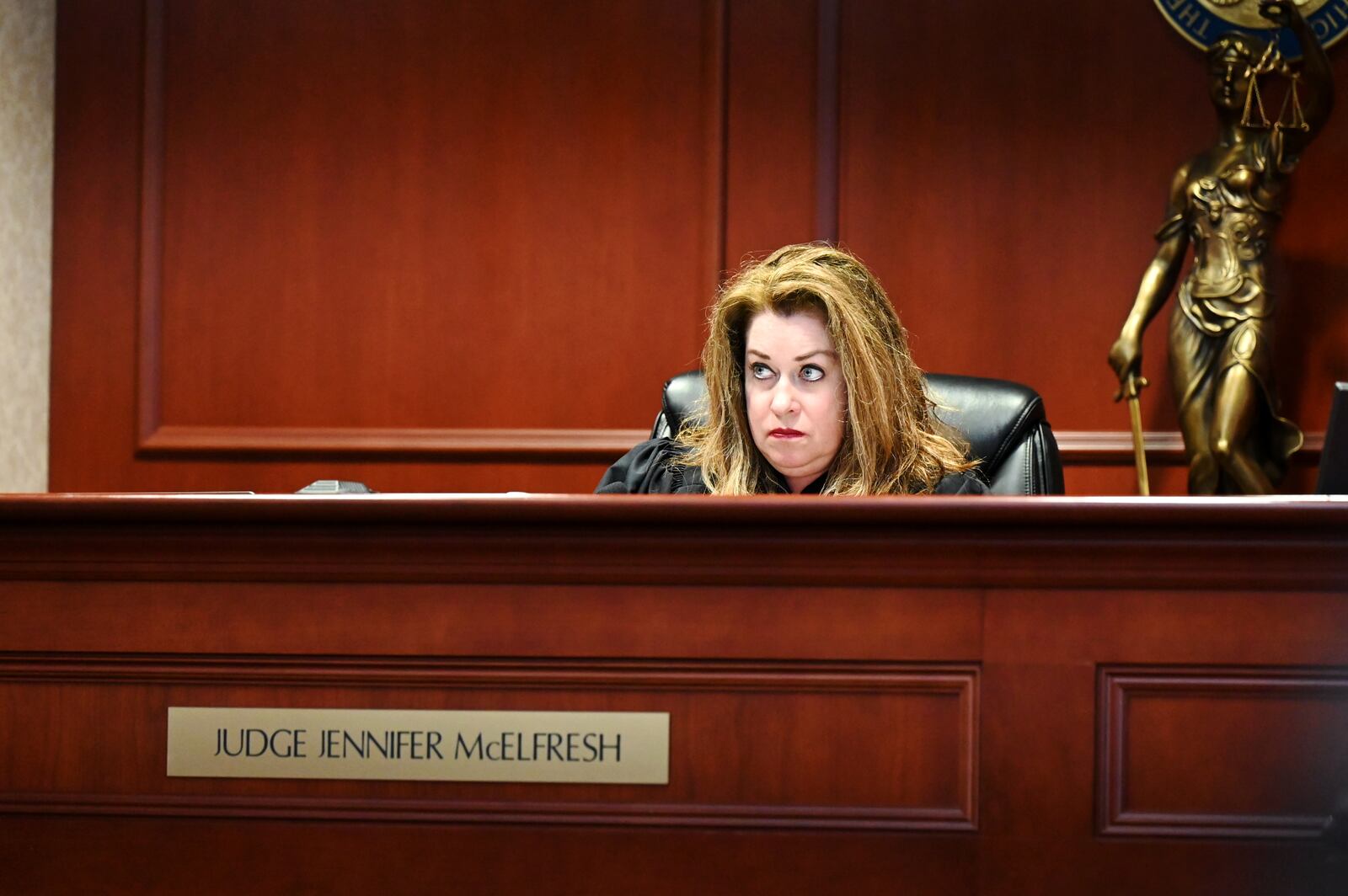 Dominick Grubb, 18, of Hamilton, was indicted last month on attempting to hire a person to kill a woman allegedly involved in another case he's involved with, an aggravated robbery from November 2024. Pictured is Butler County Common Pleas Judge Jennifer McElfresh as she listens to Grubb telling her he no longer wants to have defense attorney Arica Underwood to represent him and plans to retain a new attorney. MICHAEL D. PITMAN/STAFF