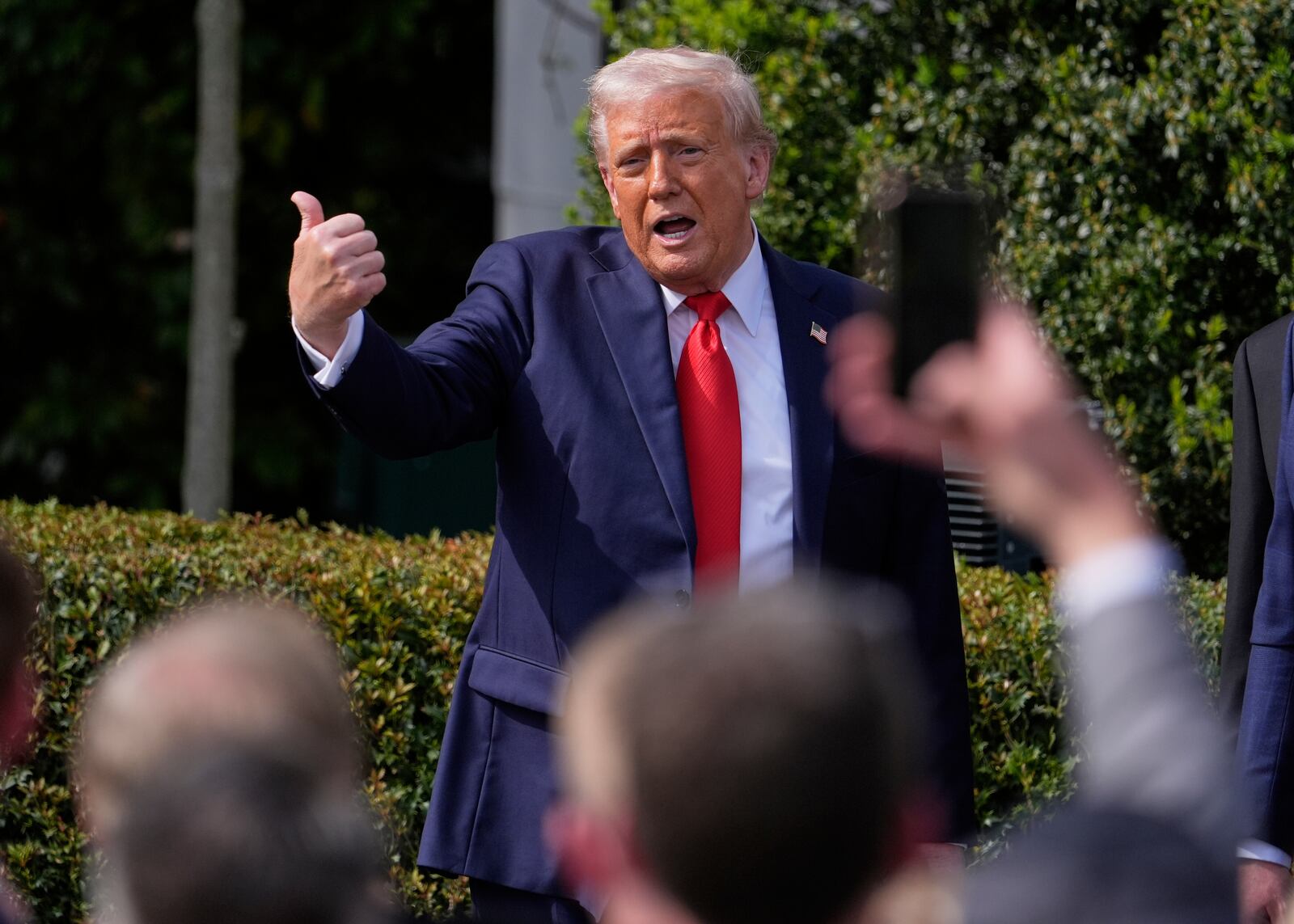 President Donald Trump gestures to the crowd as he departs after welcoming the 2025 College Football National Champions, the Ohio State University football team, during an event on the South Lawn of the White House, Monday, April 14, 2025, in Washington. (AP Photo/Manuel Balce Ceneta)