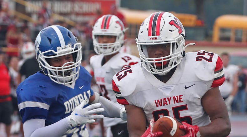 Wayne's Jordan Ward carries the ball in for a touchdown against Dunbar during Friday's game. BILL LACKEY/STAFF