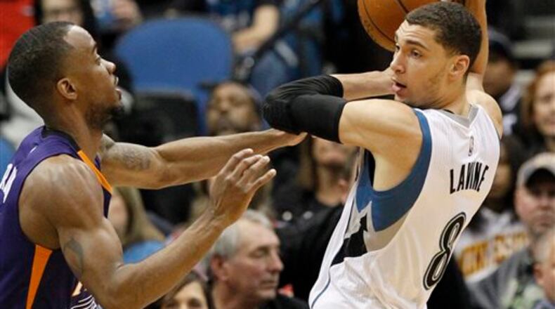 Minnesota Timberwolves guard Zach LaVine, right, keeps the ball out of reach of Phoenix Suns guard Lorenzo Brown, left, during the second half of an NBA basketball game in Minneapolis, Sunday, Jan. 17, 2016. (AP Photo/Ann Heisenfelt)