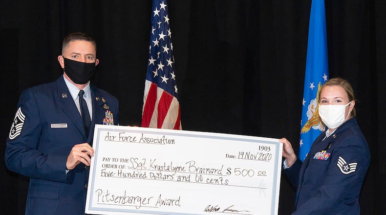 Chief Master Sgt. Jason Shaffer, 88th Air Base Wing command chief, presents Staff Sgt. Krystalynne Brainard with the Pitsenbarger Award during the Community College of the Air Force graduation ceremony Nov. 19 at the National Museum of the Air Force. The Air Force Association’s Pitsenbarger Award is given in recognition of outstanding education achievement. U.S. AIR FORCE PHOTO/R.J. ORIEZ
