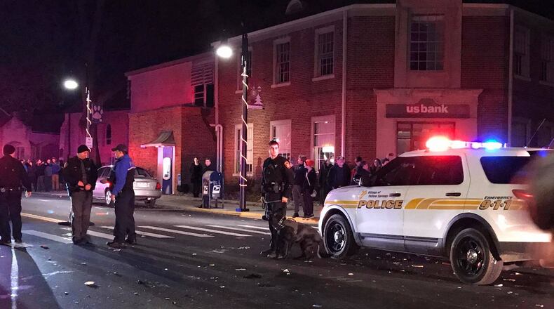 Yellow Springs police are seen early New Year’s Day after an apparent clash with revelers following an annual ball drop event in the village. MARGARET KINNER FISCHER / CONTRIBUTED