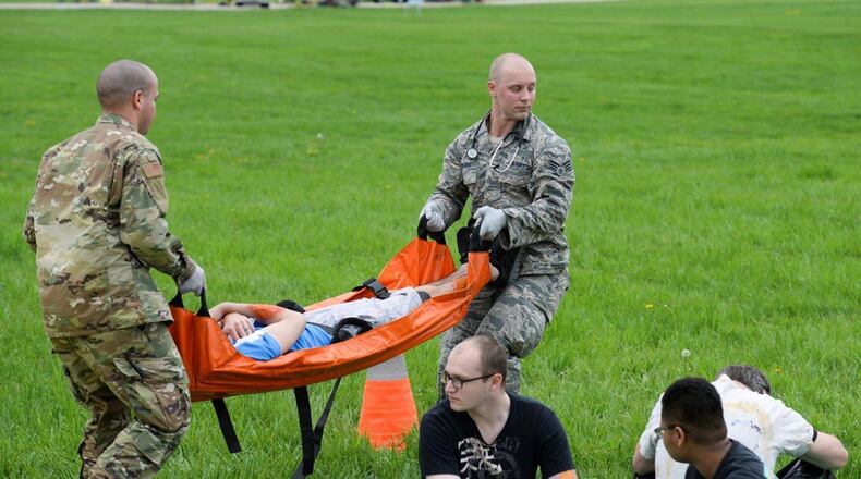 Senior Airmen Stephen Cotto-Nunez and Matthew Presnal, both medics from the 88th Medical Group, carry a volunteer victim during a base mass casualty exercise at Huffman Prairie Flying Field May 2. (U.S. Air Force photo/Wesley Farnsworth)