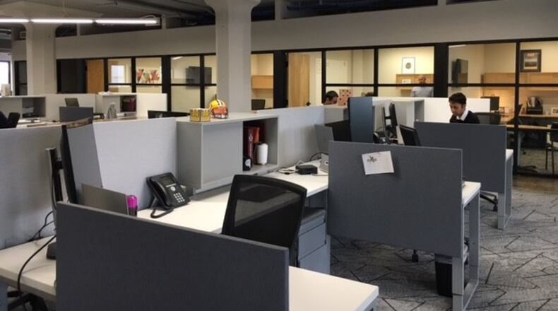 Employees at work at the new offices of Ascend Innovations and the Greater Dayton Area Hospital Association. THOMAS GNAU/STAFF