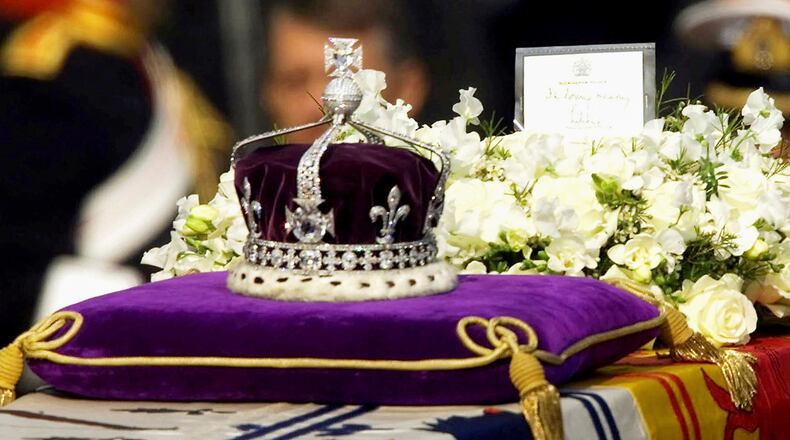 FILE - The Koh-i-Noor diamond, set in the Maltese Cross at the front of the crown made for Britain's late Queen Mother, is seen on her coffin as it is drawn to London's Westminster Hall on April 5, 2002. (AP Photo/Alastair Grant, File)