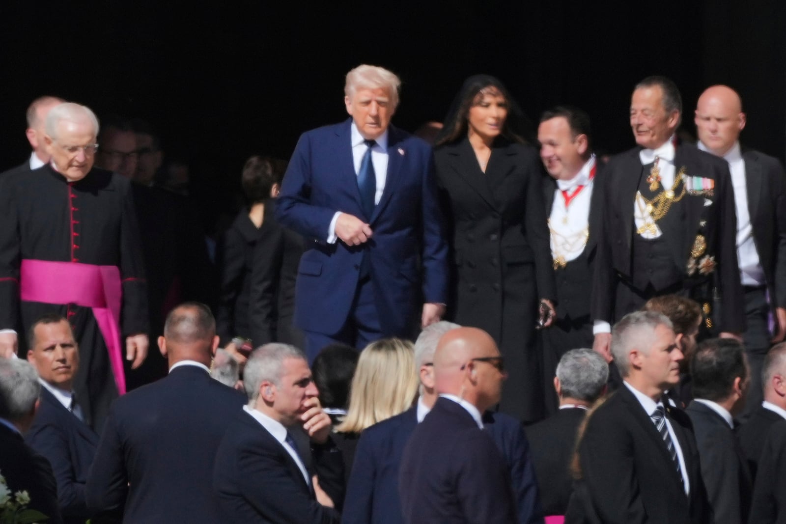 President Donald Trump and first lady Melania Trump, center, and other guests arrive, for the funeral of Pope Francis in St. Peter's Square at the Vatican, Saturday, April 26, 2025. (AP Photo/Andrew Medichini)