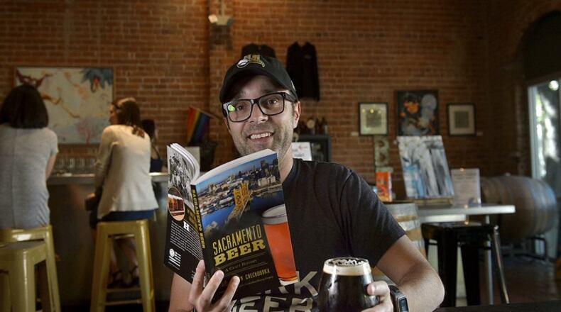 Author of the new book "Sacramento Beer: A Craft History" Justin Chechourka enjoys a glass of beer at Big Stump brewery in Sacramento, Calif. on Friday, May 4, 2018. (Randall Benton/Sacramento Bee/TNS)
