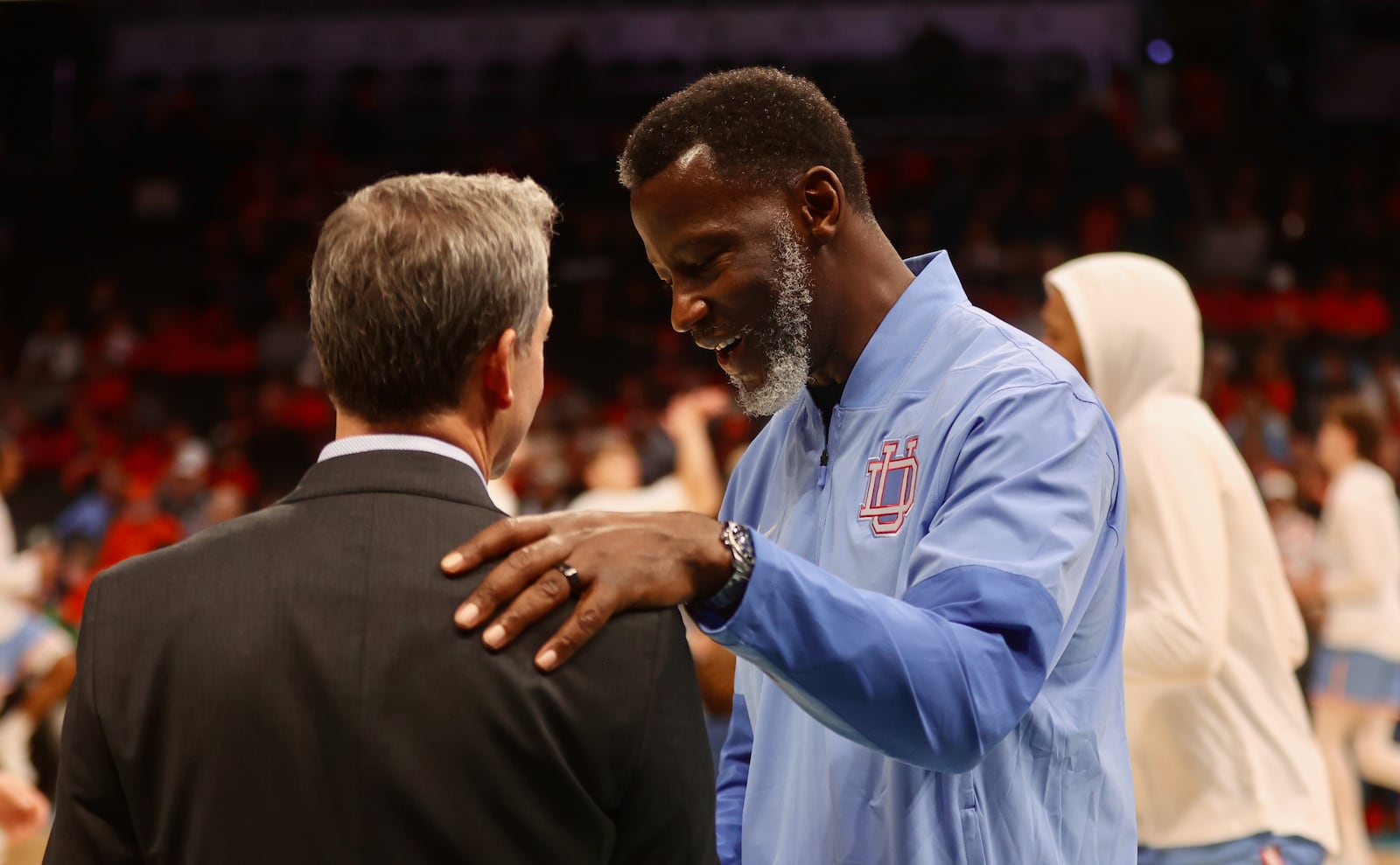 Dayton's Anthony Grant, right, talks to Virginia's Ryan Odom before the game on Saturday, Dec. 6, 2025, at the Spectrum Center in Charlotte, N.C. David Jablonski/Staff