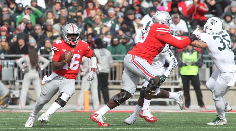 Ohio State’s J.T. Barrett runs against Michigan State on Saturday, Nov. 11, 2017, at Ohio Stadium in Columbus. David Jablonski/Staff
