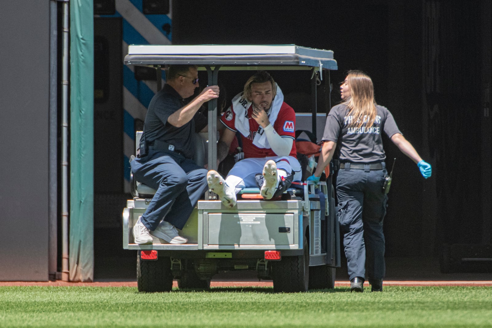 Cleveland Guardians' Gabriel Arias, center, is taken from the field after an injury by medical personnel during the third inning of a baseball game against the St. Louis Cardinals, Sunday, June 29, 2025, in Cleveland. (AP Photo/Phil Long)