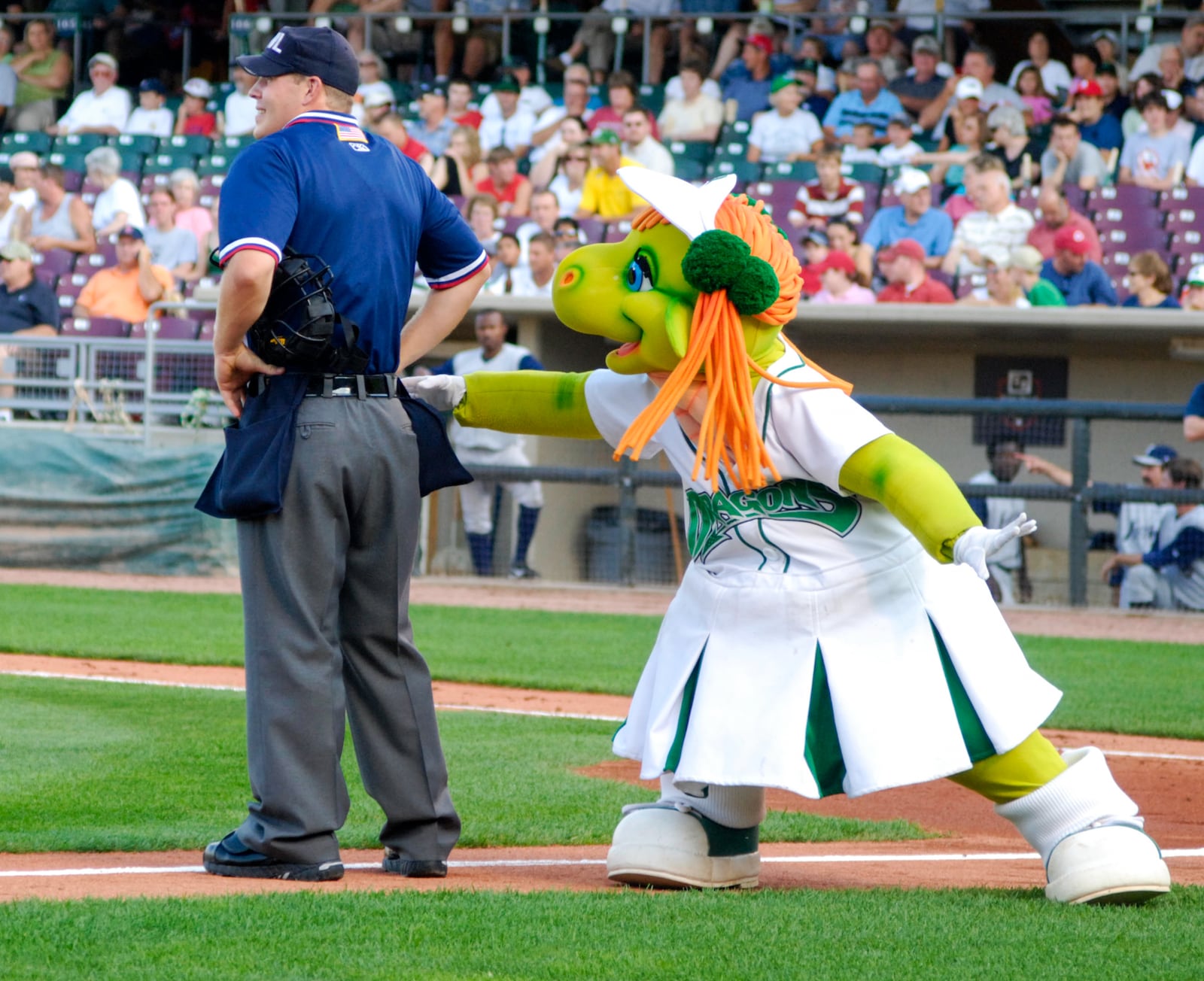 Gem, on of the mascots for the Dayton Dragons, sneaks baseballs from an umpire and throws them to the crowd on August 5, 2008.