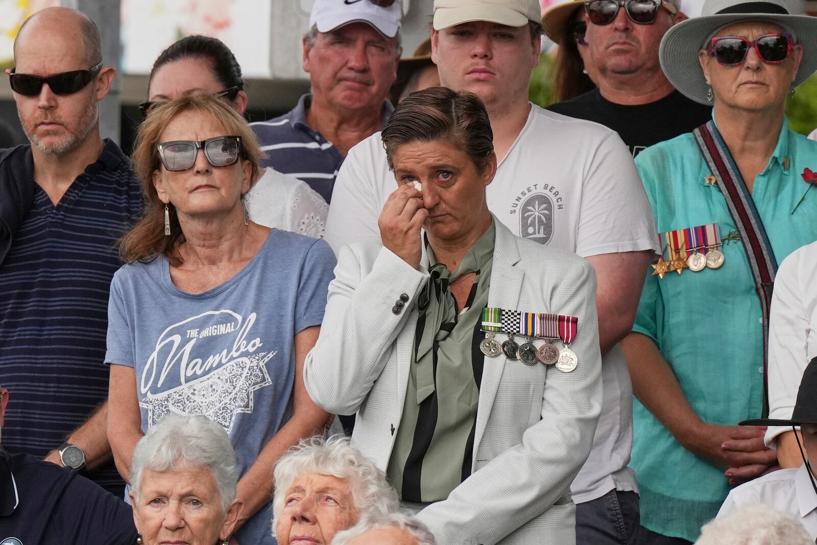 A woman reacts during the Anzac Day commemorations in Nelson Bay, Australia, Friday, April 25, 2025. (AP Photo/Mark Baker)
