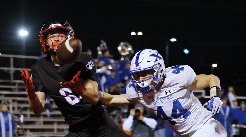 Lakota West's Finn Mason intercepts a pass intended for St. Xavier's Jake Britt during their Division 1 playoff football game Friday, Nov. 15, 2024 at Princeton's Mancuso Field in Sharonville. St. Xavier won 16-13 to advance. NICK GRAHAM/STAFF