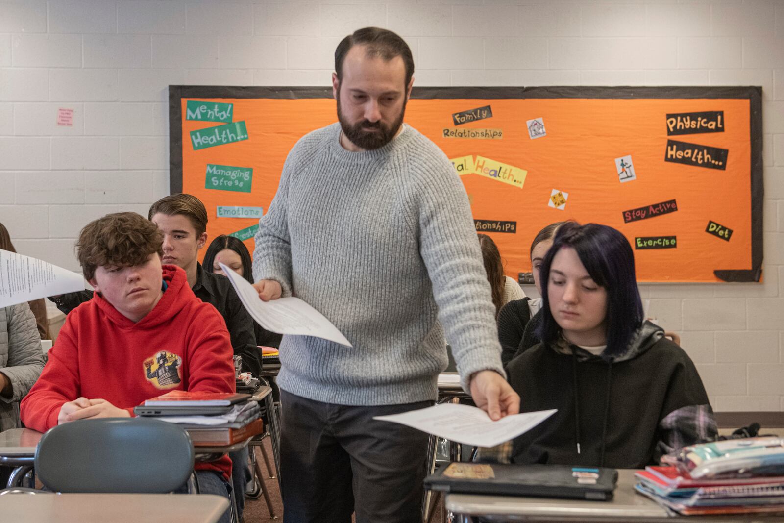 Mansfield Senior High School teacher Tony Davis hands out work sheets to his health class about the topic of sleep Friday, Dec. 6, 2024, in Mansfield, Ohio. (AP Photo/Phil Long)