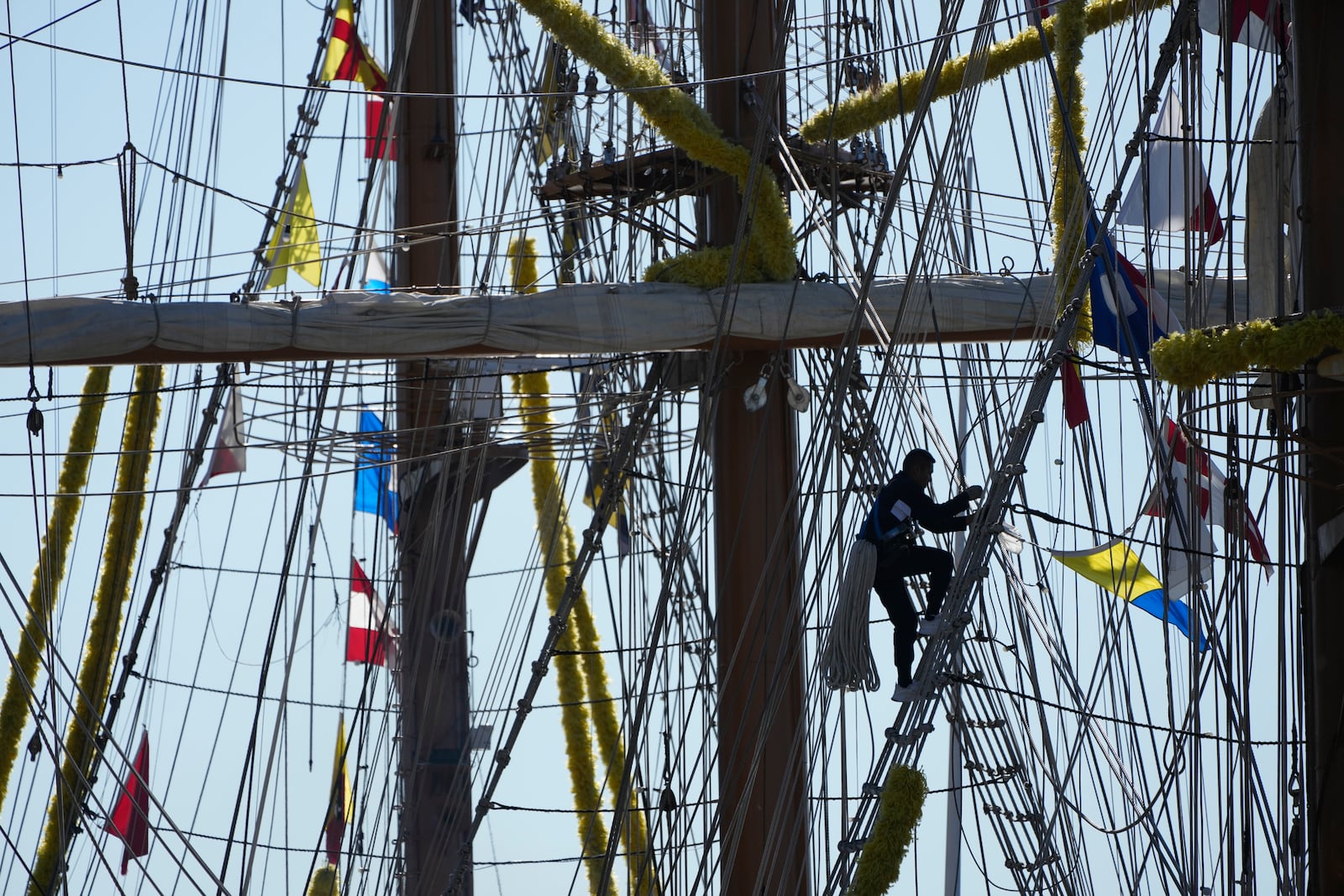 A person climbs up the rigging of the Cuauhtemoc, a masted Mexican Navy training ship, at Pier 35 after it collided with the Brooklyn Bridge in New York, Monday, May 19, 2025. (AP Photo/Seth Wenig)