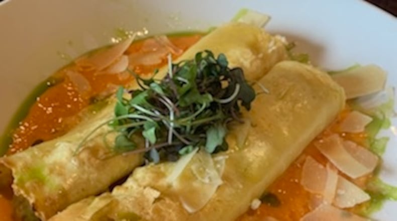 Watermark's house manicotti is filled with summer vegetable ratatouille (zucchini, squash, caramelized onion), ricotta and parmesan, topped with a smoky red
pepper cream sauce. CONTRIBUTED