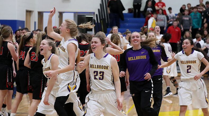 The Bellbrook girls basketball team celebrate the victory over Tipp Friday during the Regional finals at Springfield High School. Bill Lackey/Staff