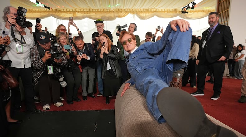 Academy Awards host Conan O'Brien poses atop a roll of red carpet during the annual Oscars red carpet roll out on Wednesday, March 11, 2026, at the Dolby Theatre in Los Angeles. (AP Photo/Chris Pizzello)