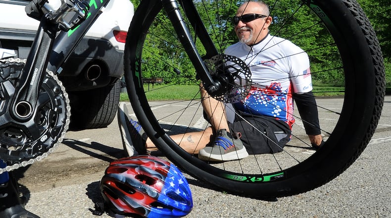 Gil Esparza stretches before he goes on his bike ride near Xenia, Wednesday May 17, 2023. Esparza is the founder of Warriors on Wheels, which supplies bicycles to military and veterans across the country. MARSHALL GORBY\STAFF