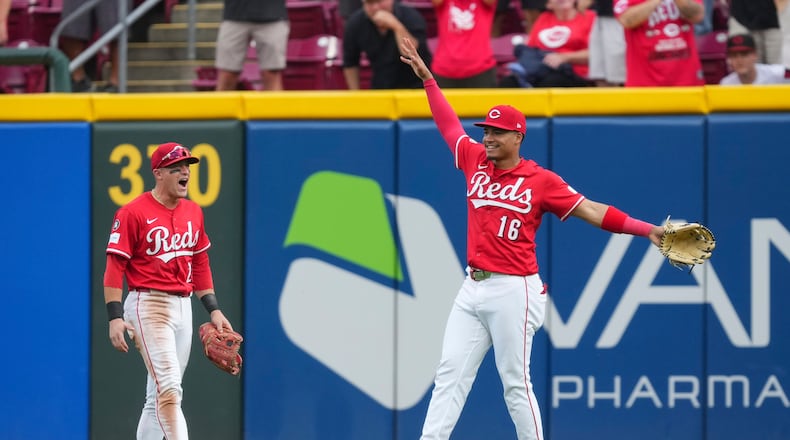 Cincinnati Reds outfielder Noelvi Marte (16) celebrates with teammate TJ Friedl (29) after catching a fly ball hit by Pittsburgh Pirates' Bryan Reynolds during the ninth inning of a baseball game, Thursday, Sept. 25, 2025, in Cincinnati. (AP Photo/Jeff Dean)