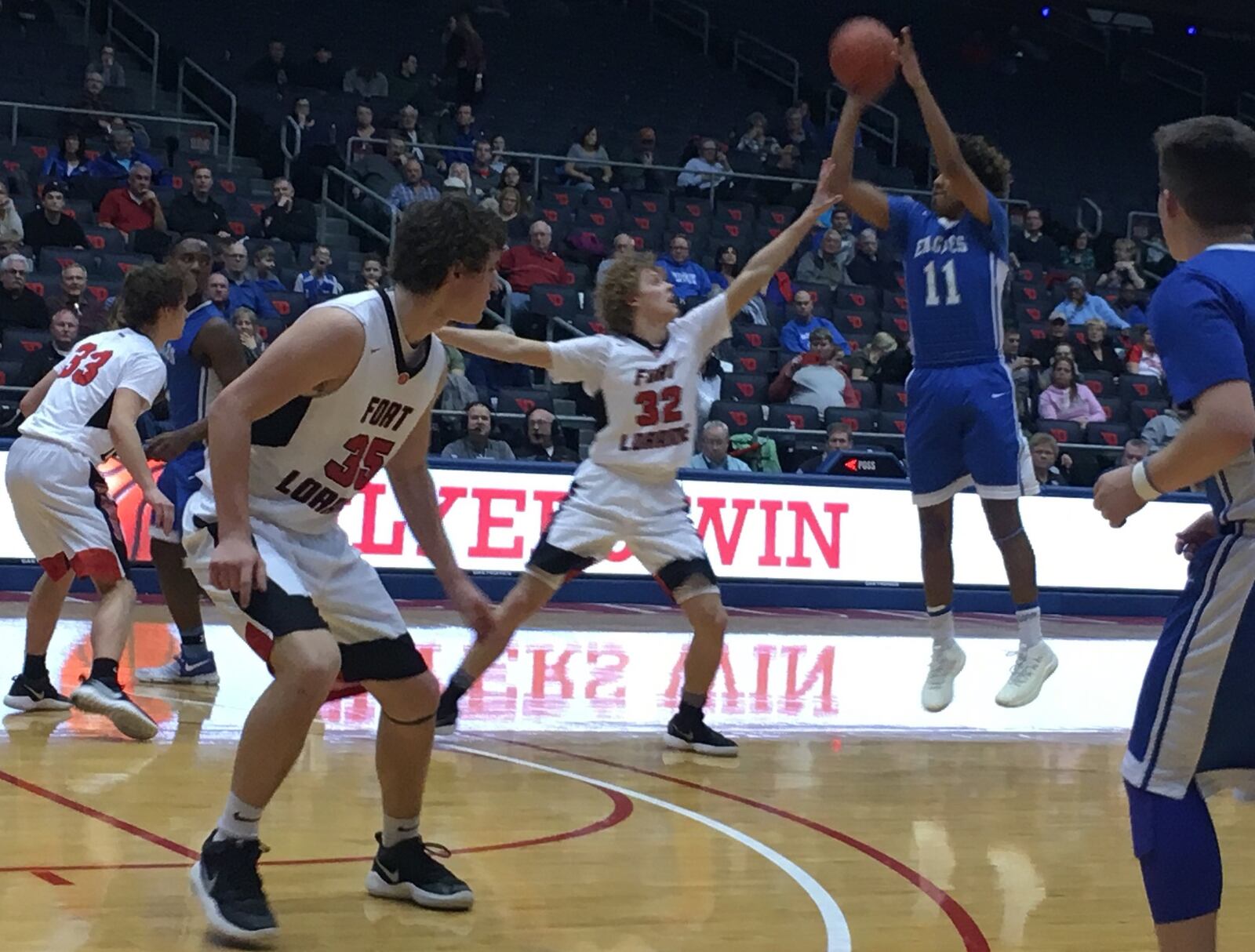 Middletown Christian’s C.J. Money (11) launches a shot over Fort Loramie’s Dillon Braun (32) during Friday night’s Division IV district final at the University of Dayton Arena. RICK CASSANO/STAFF