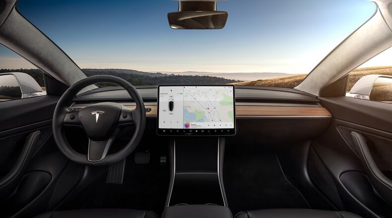 The Tesla Model 3 s minimalist interior with its 15-inch touchscreen as a focal point. Tesla Chief Executive Elon Musk says the next update to Tesla s operating system will include classic video games from Atari. (Tesla)