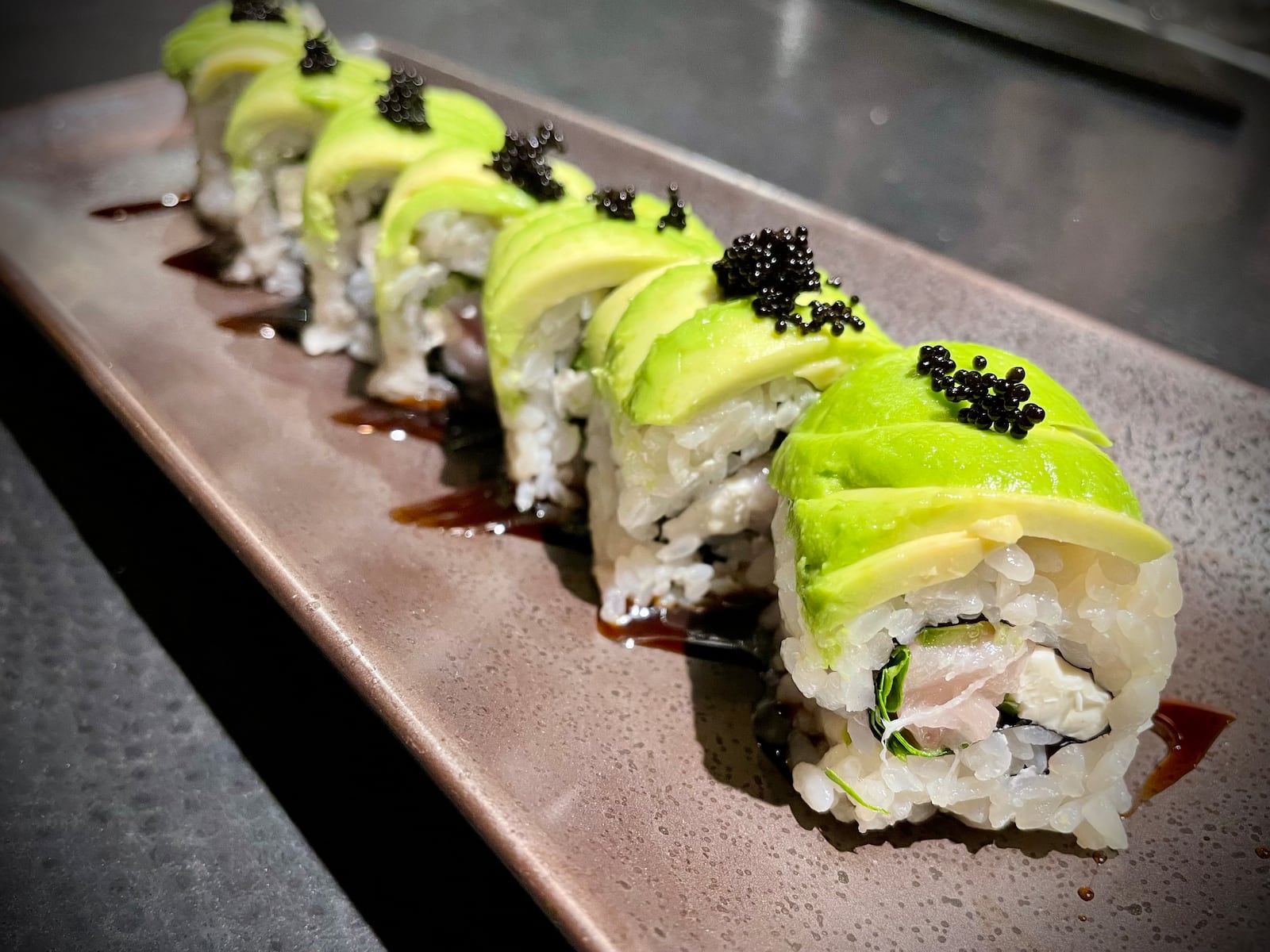 Dozo, an elevated sushi experience in the back room of Tender Mercy in downtown Dayton, has reopened with a new chef and menu. NATALIE JONES/STAFF